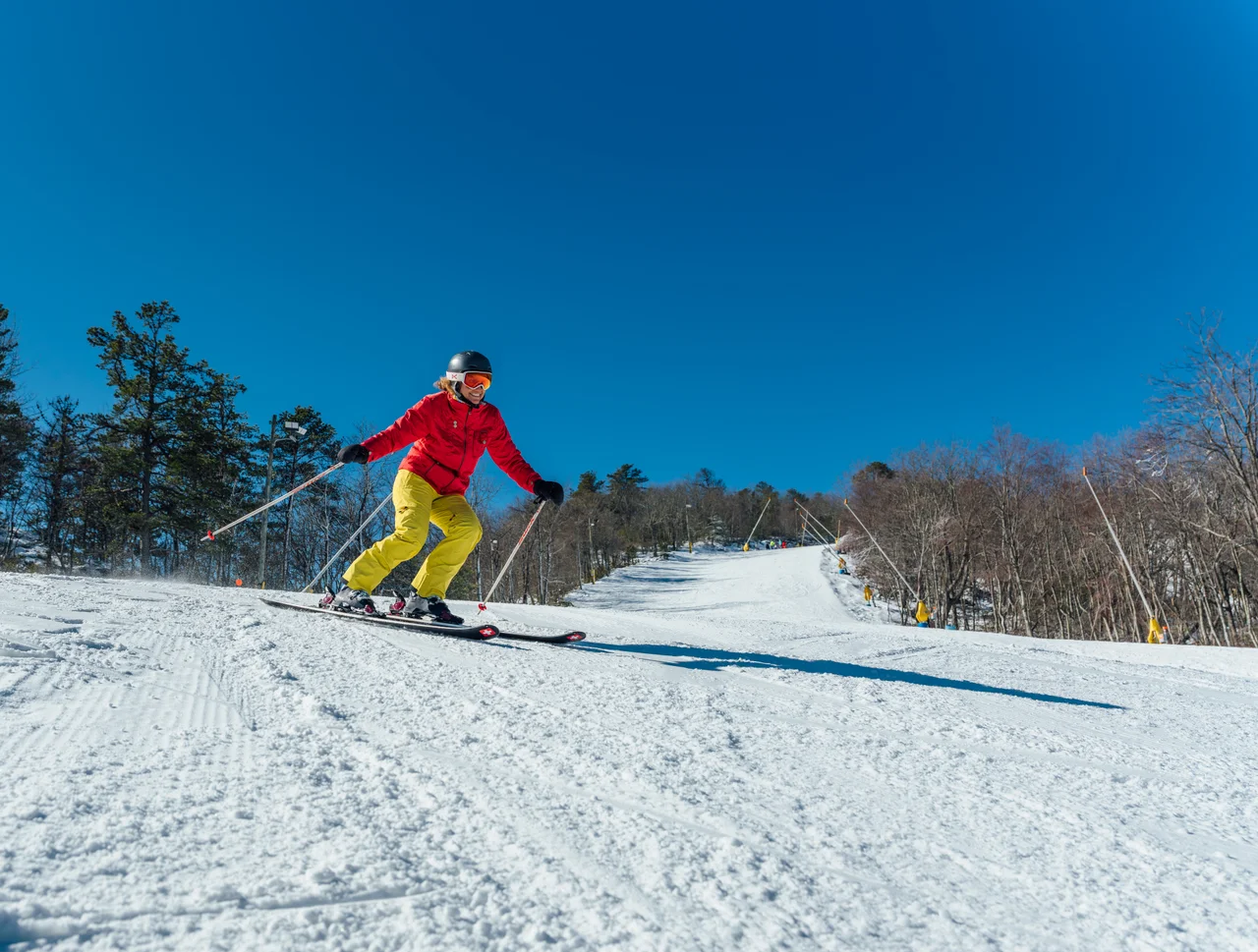 Massanutten ski area general skier in red and yellow on snow 11