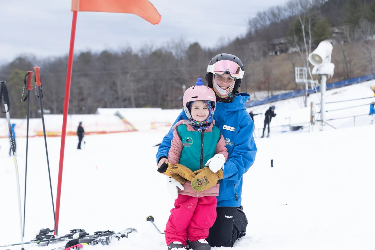 Massanutten ski area lessons ski instructor holding child 10