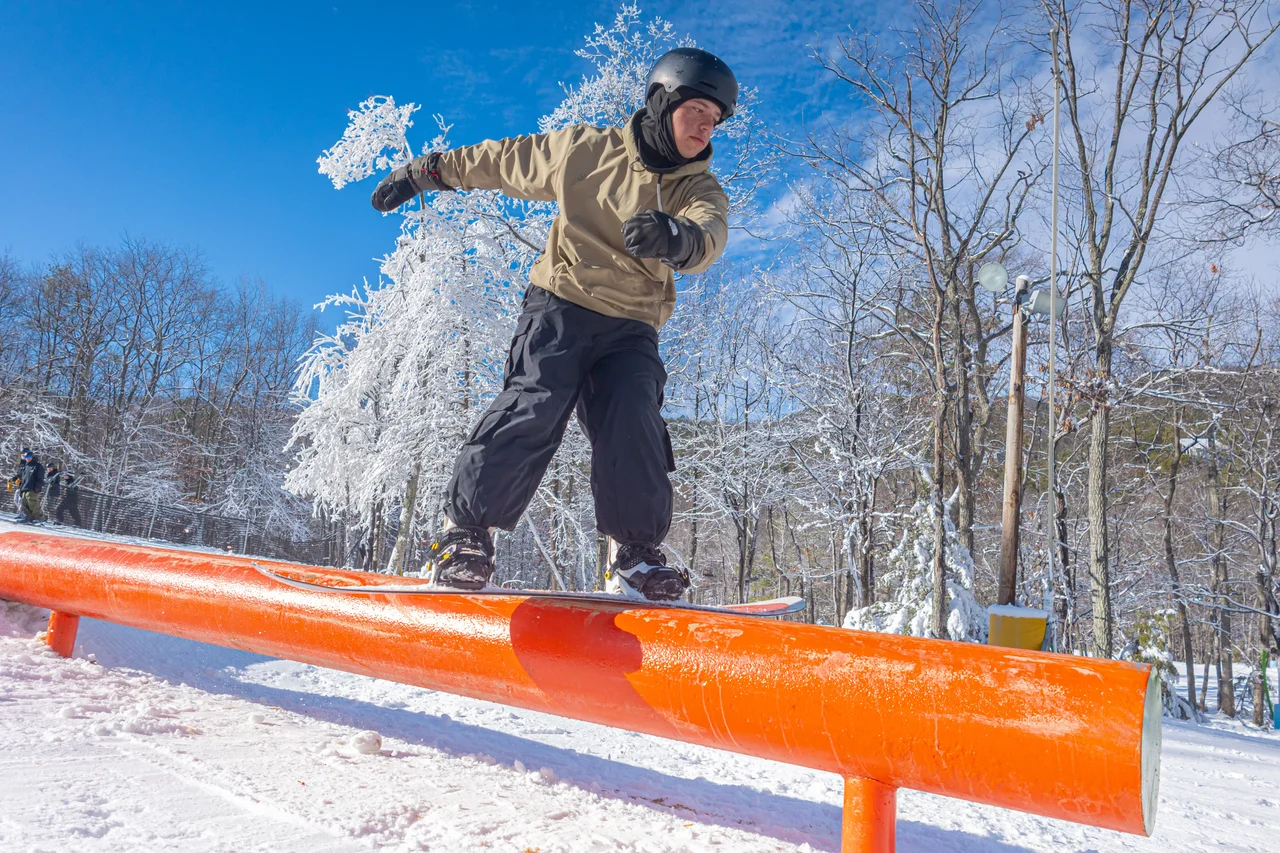 Massanutten ski area terrain park terrain park snowboarder on orange rail 04