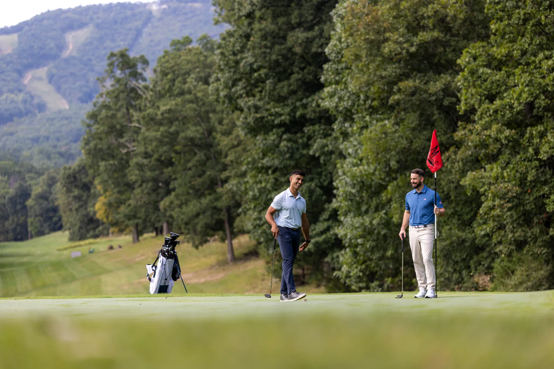 Massanutten mountain greens golfer finishing putt companion mountain green