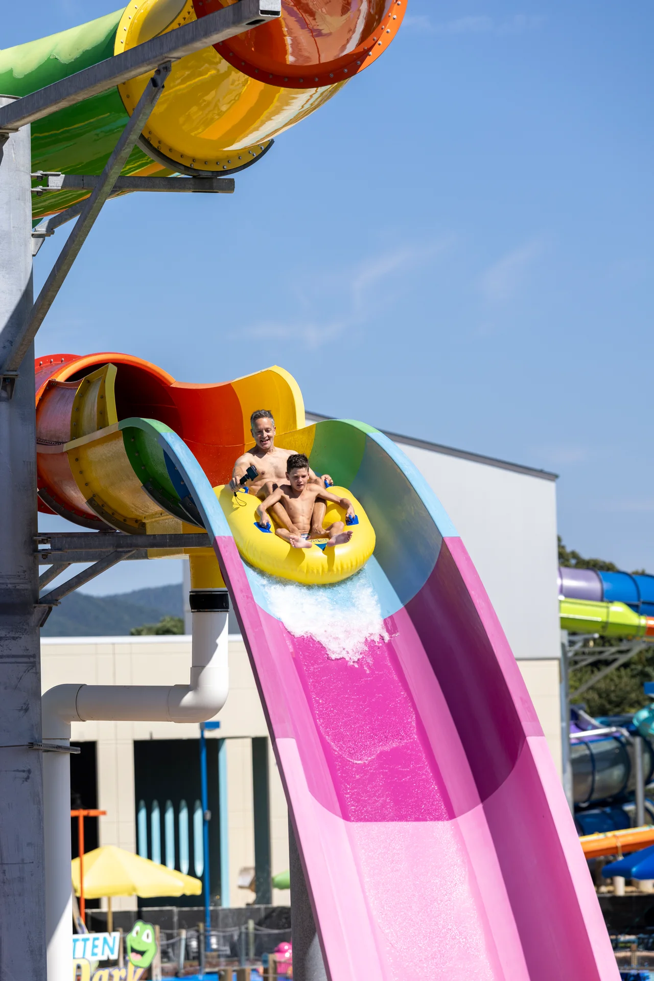 Massanutten outdoor waterpark mass mayhem two riders yellow raft rainbow slide