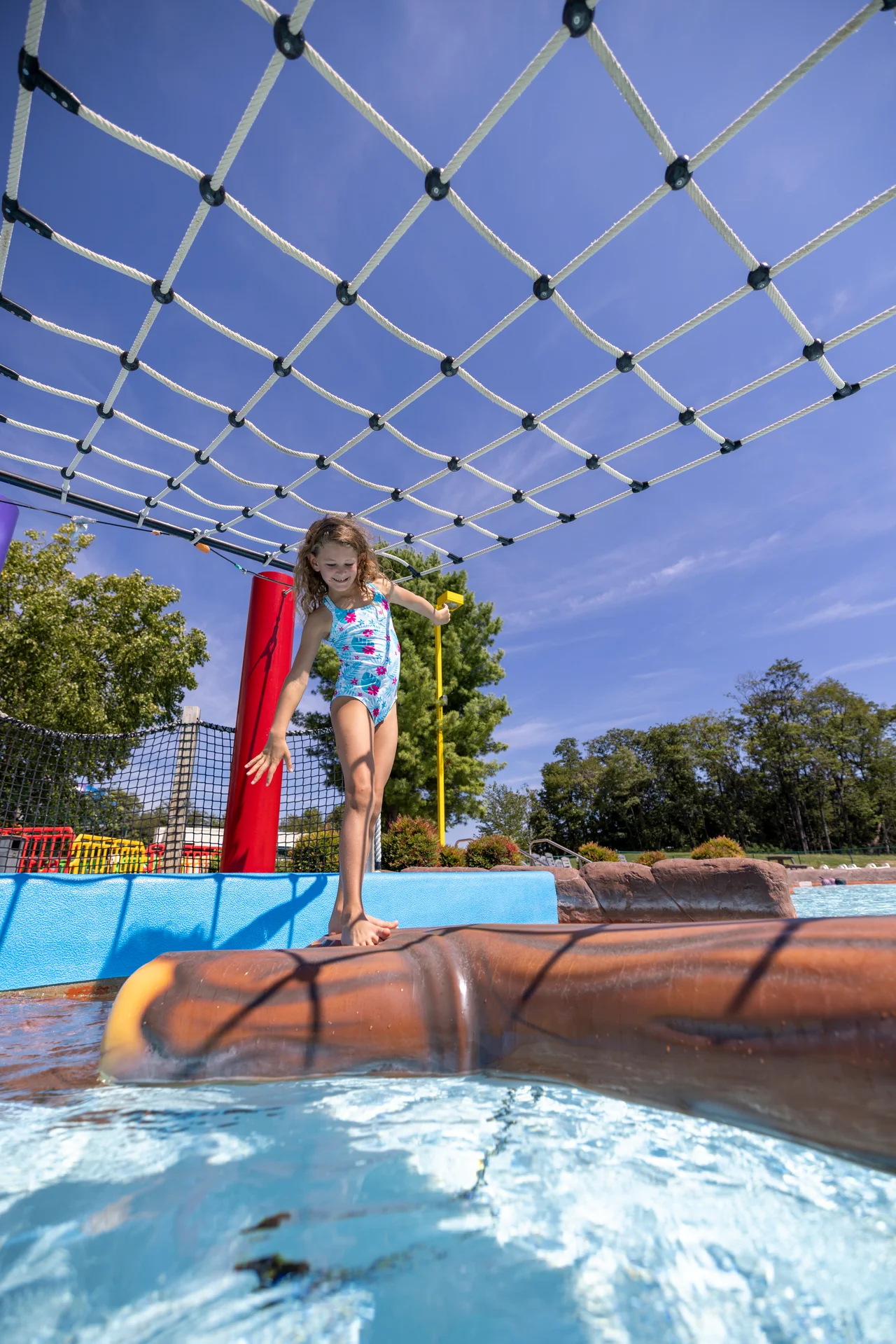 Massanutten outdoor waterpark splash a nutten girl balancing floating log