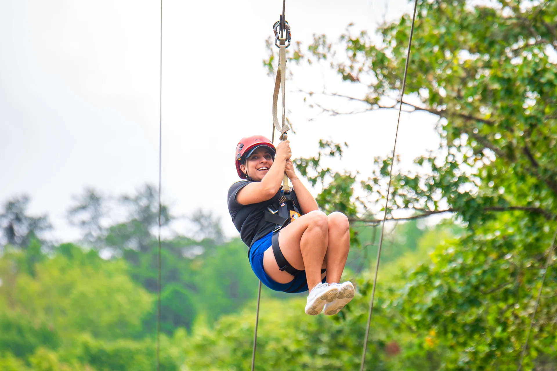 Massanutten zipline woman riding through forest