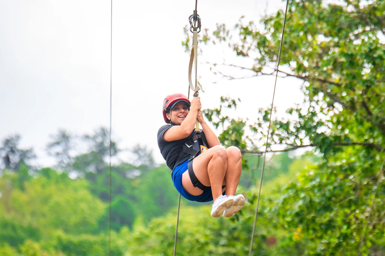 Massanutten zipline woman riding through forest