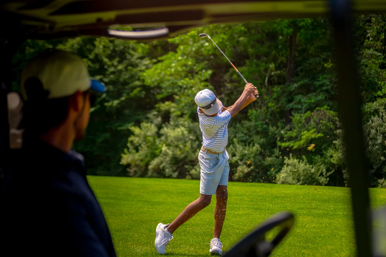 Massanutten woodstone golfer swinging from cart