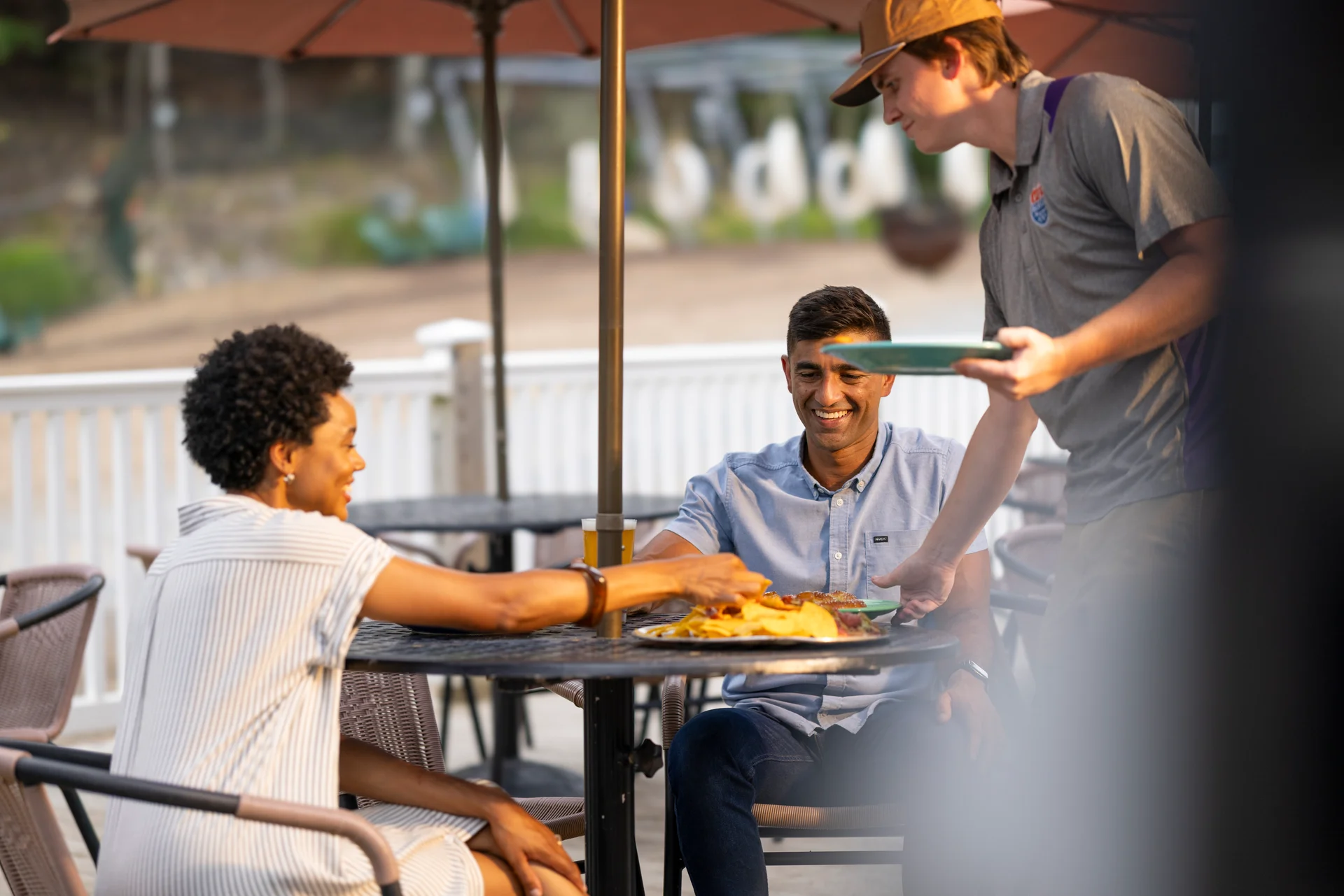 Massanutten base camp server serving couple outdoor patio lunch