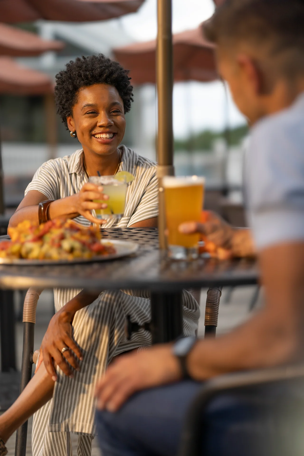 Massanutten base camp woman drink patio table companion foreground