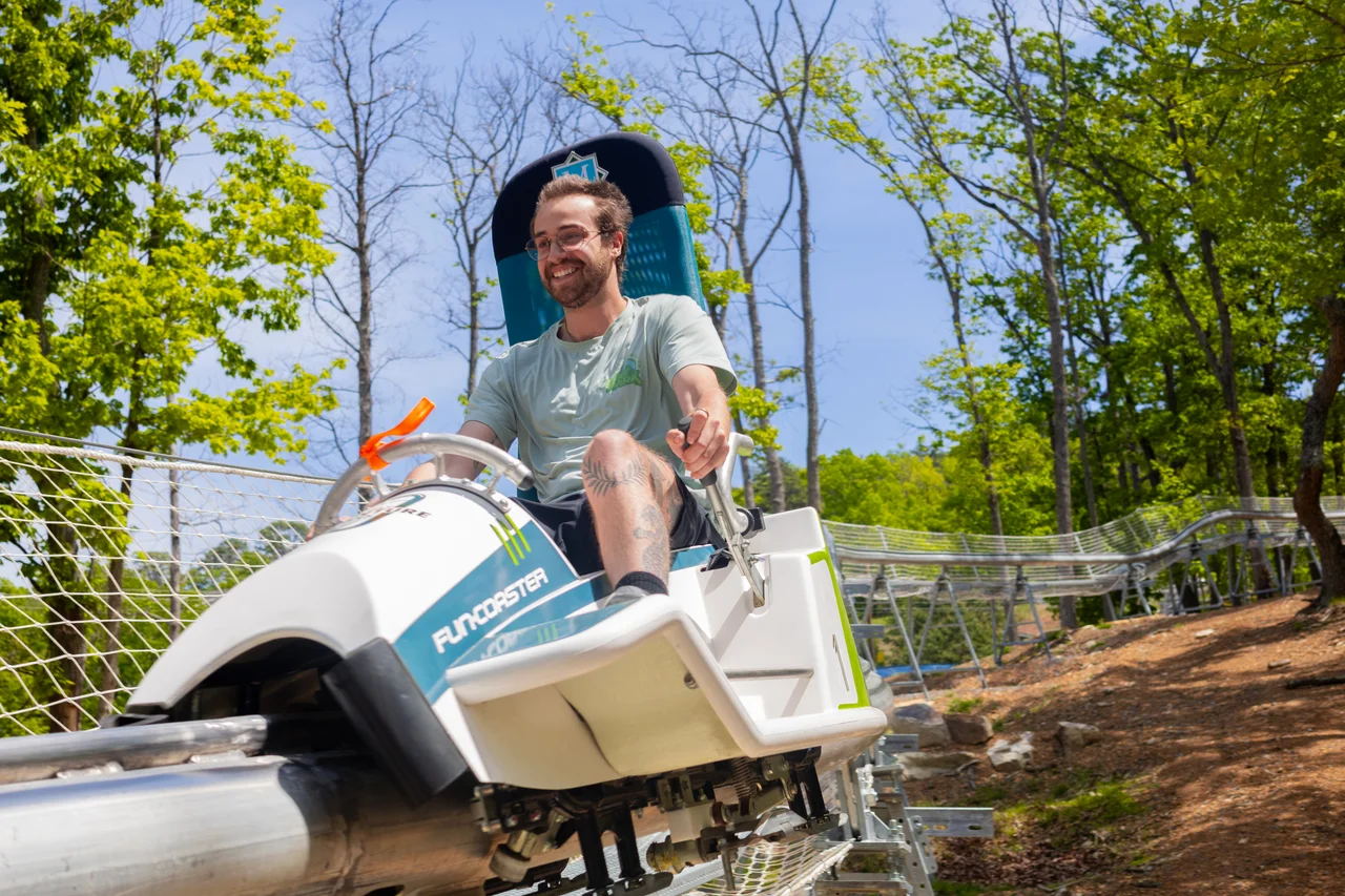Massanutten fun coaster man riding through forest