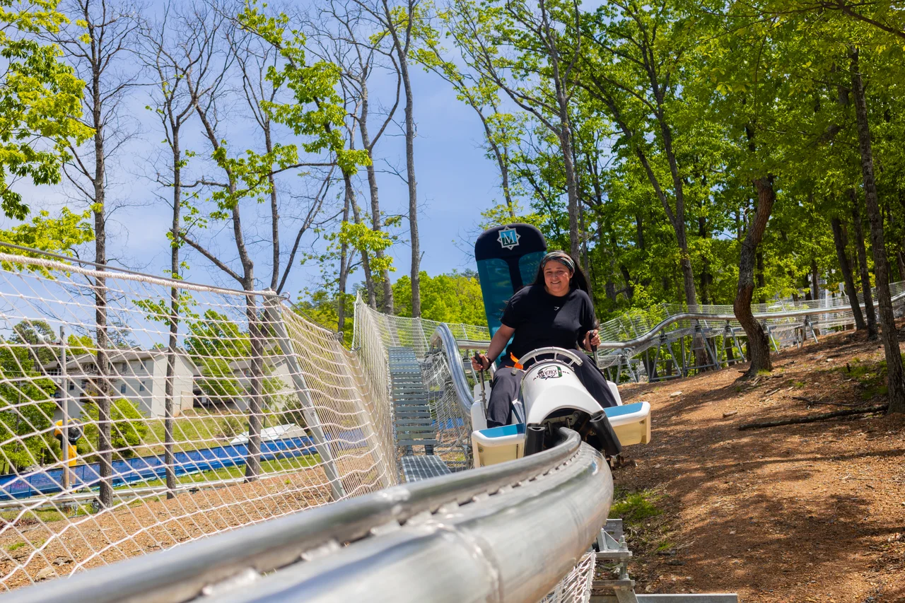 Massanutten fun coaster woman riding through forest