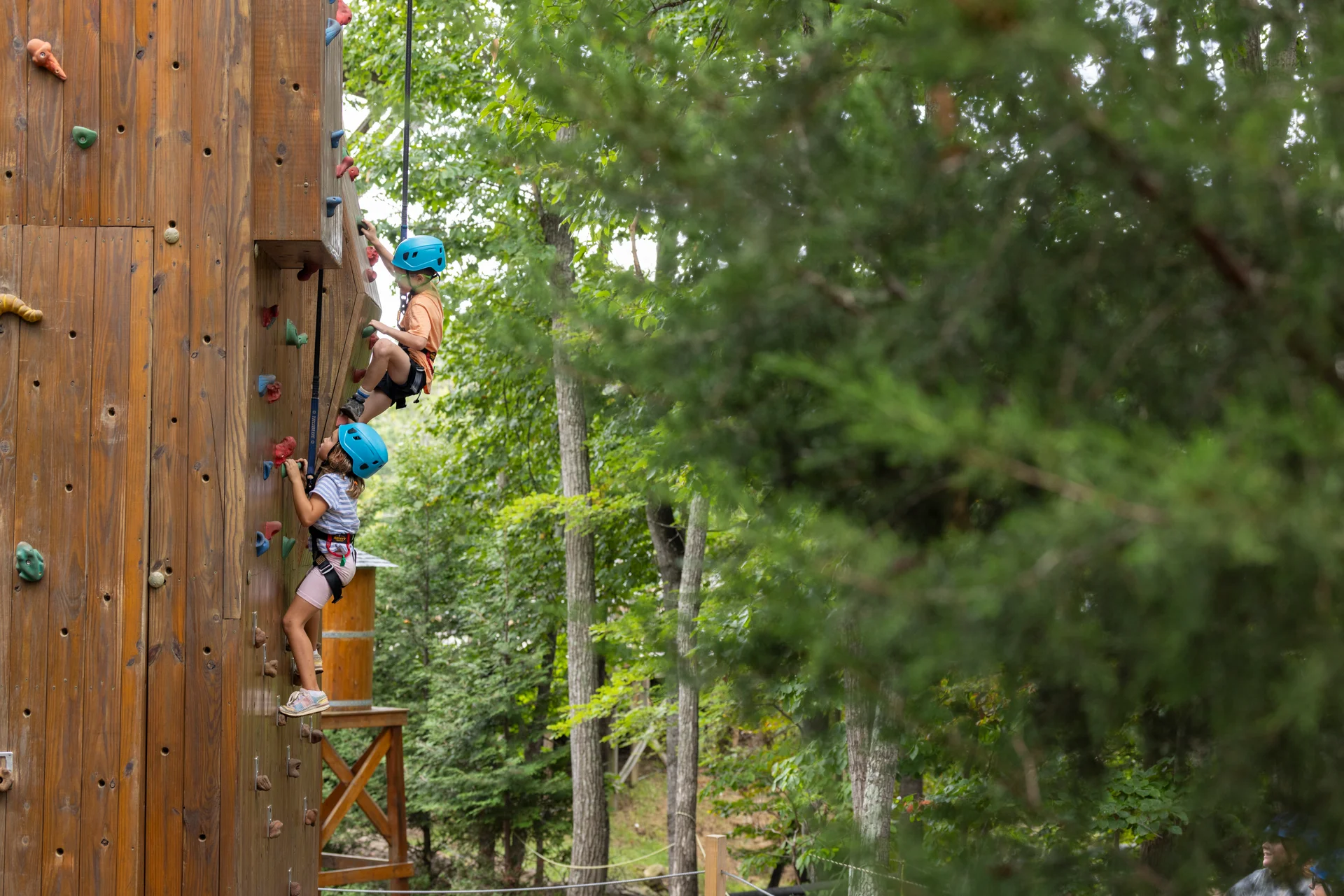Massanutten kids adventure course helmeted climbers outdoor climbing wall forest