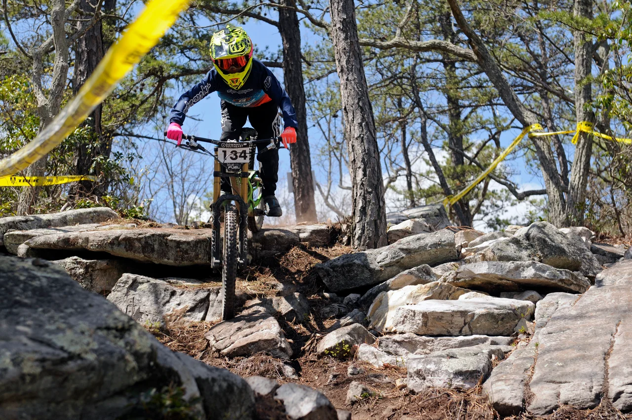 Massanutten mountain biking bike park mountain biker jumping wooded trail 26