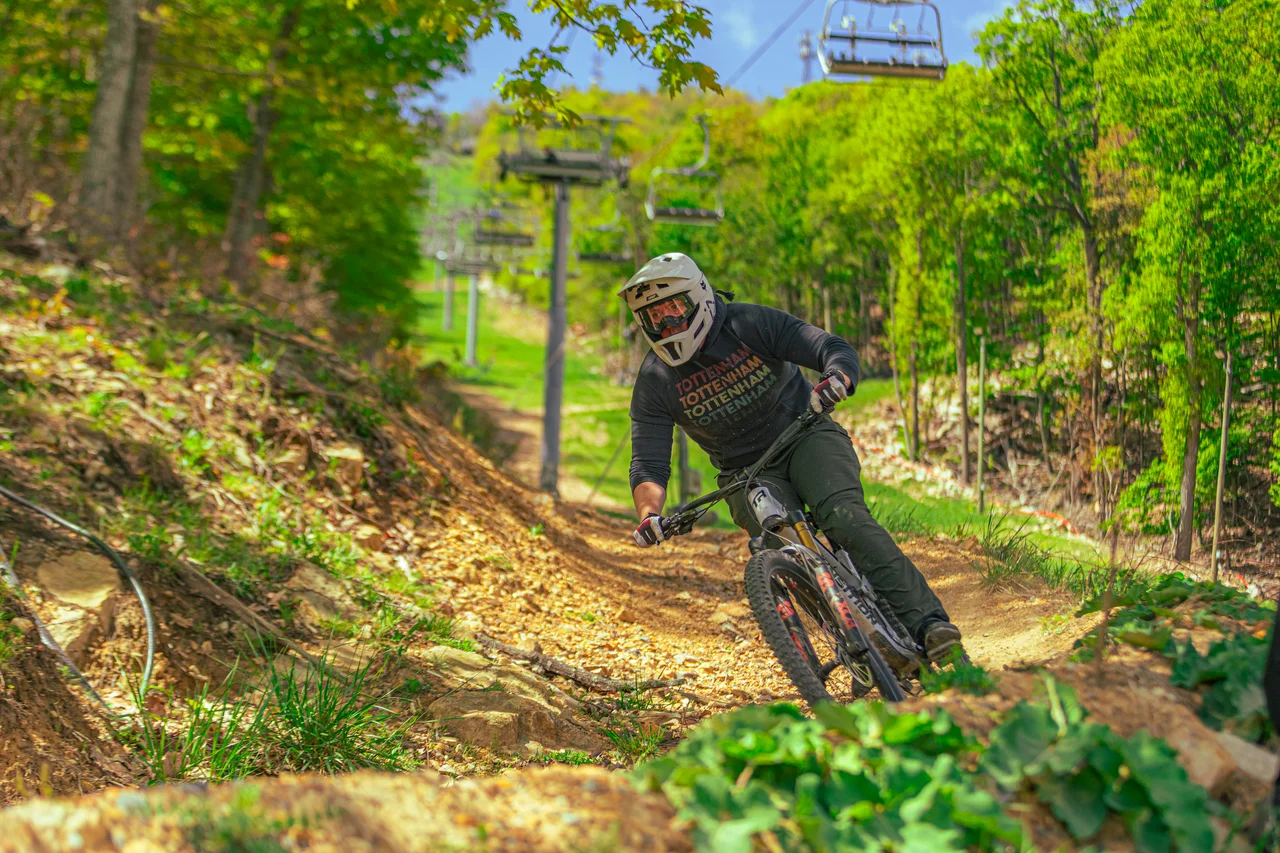 Massanutten mountain biking bike park mountain biker leaning into berm 14