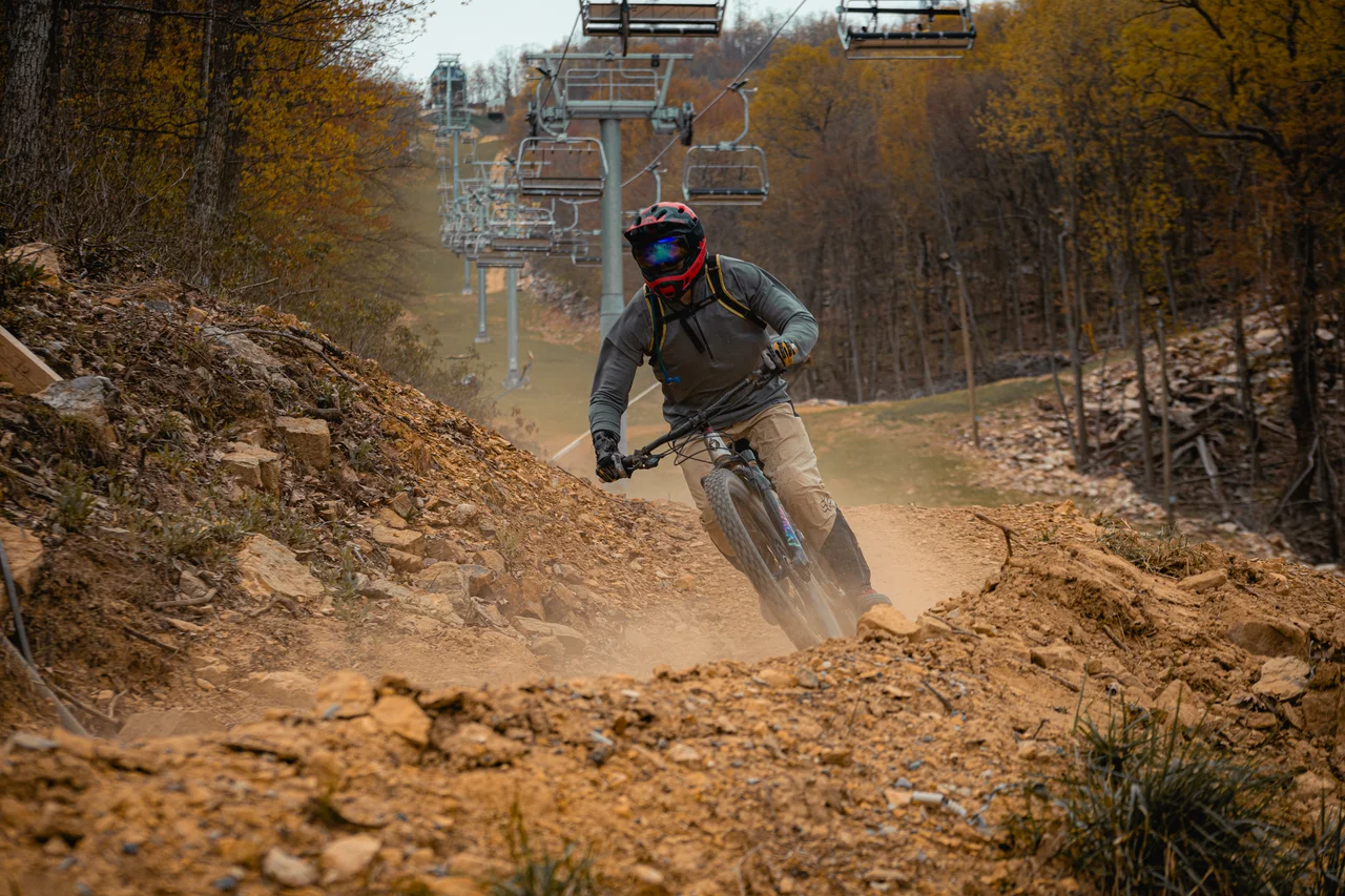 Massanutten mountain biking bike park mountain biker on autumn chairlift trail 05