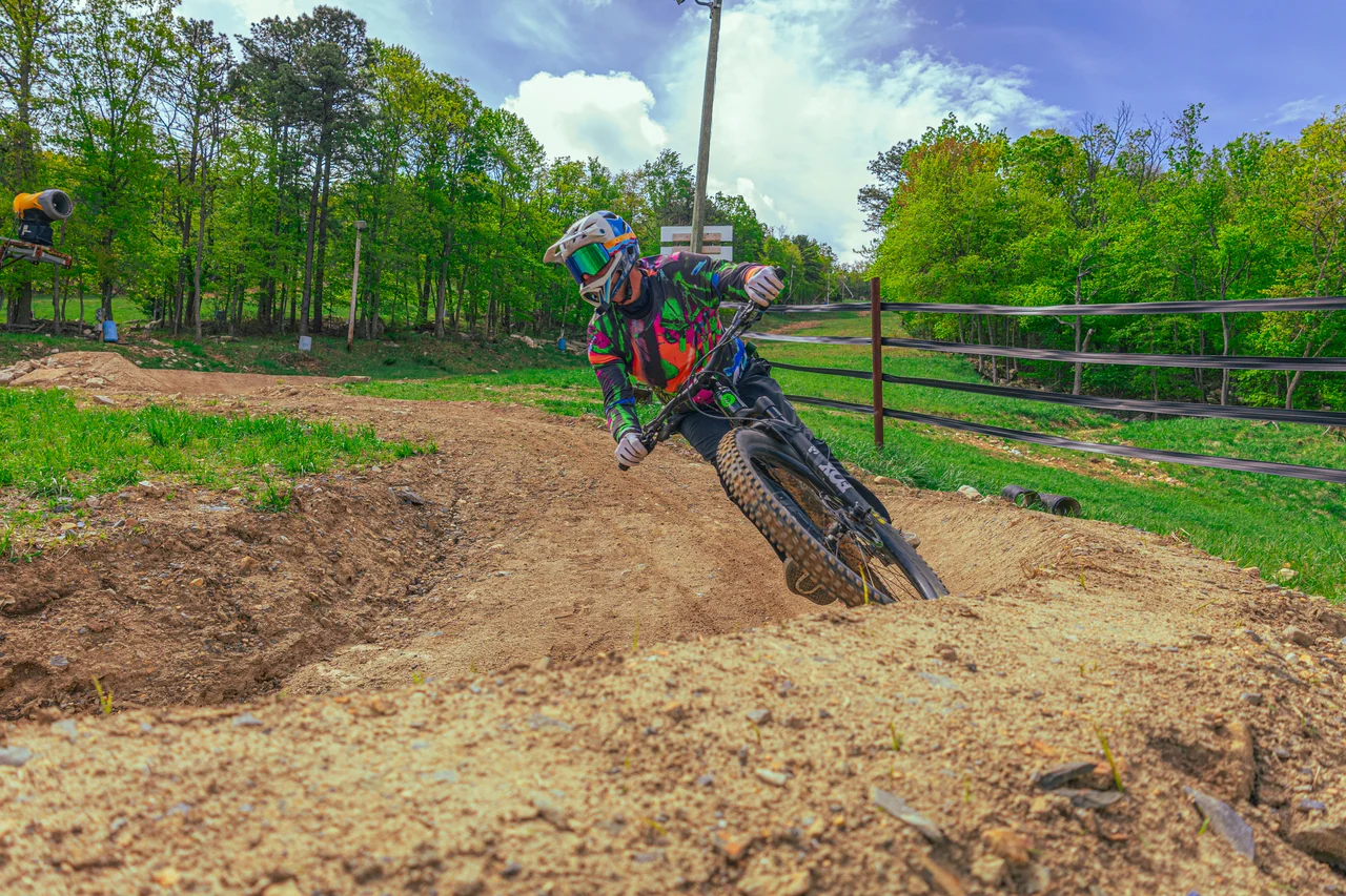 Massanutten mountain biking bike park mountain biker on berm with mountain view 11