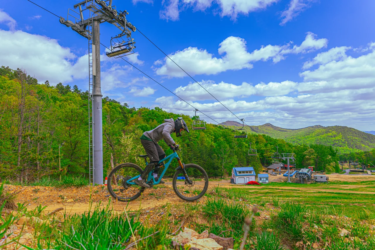 Massanutten mountain biking bike park mountain biker on dirt berm 12