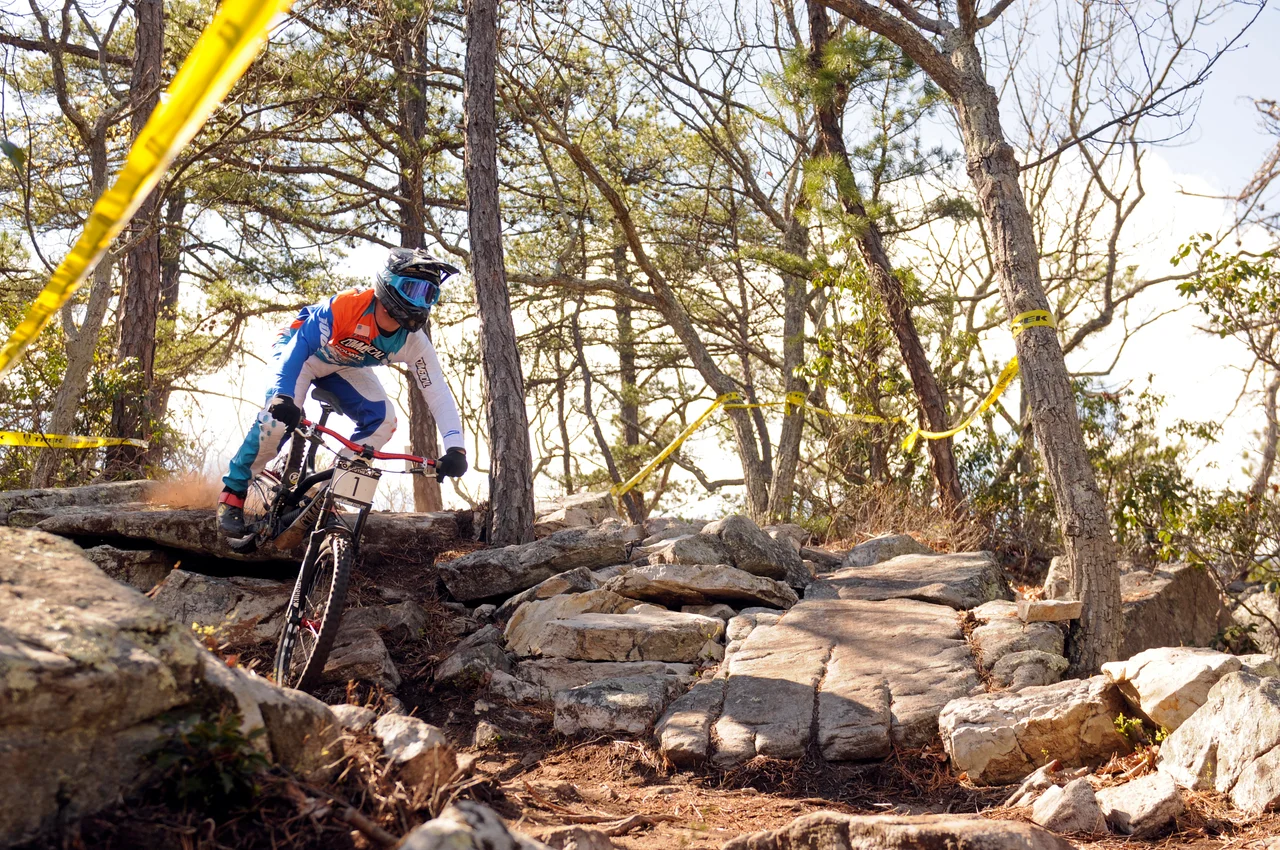 Massanutten mountain biking bike park mountain biker on rocky forest jump 27