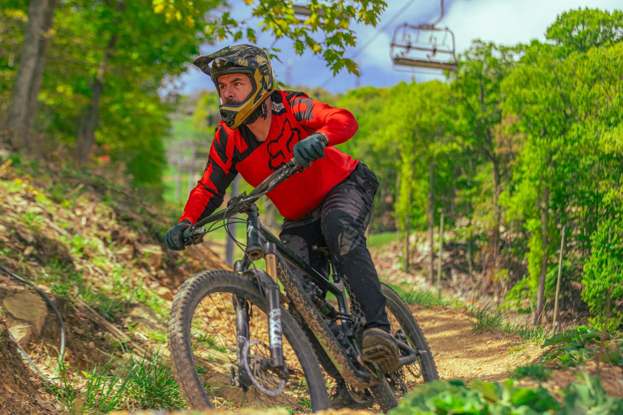 Massanutten mountain biking bike park mountain biker on wooded downhill trail 18