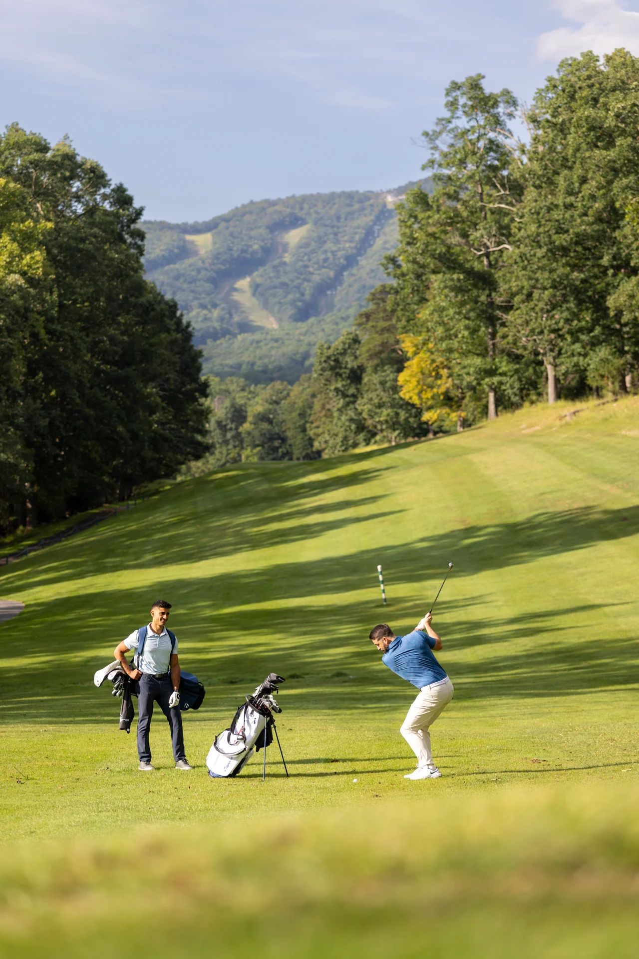 Massanutten mountain greens golfer swinging club mountain fairway portrait