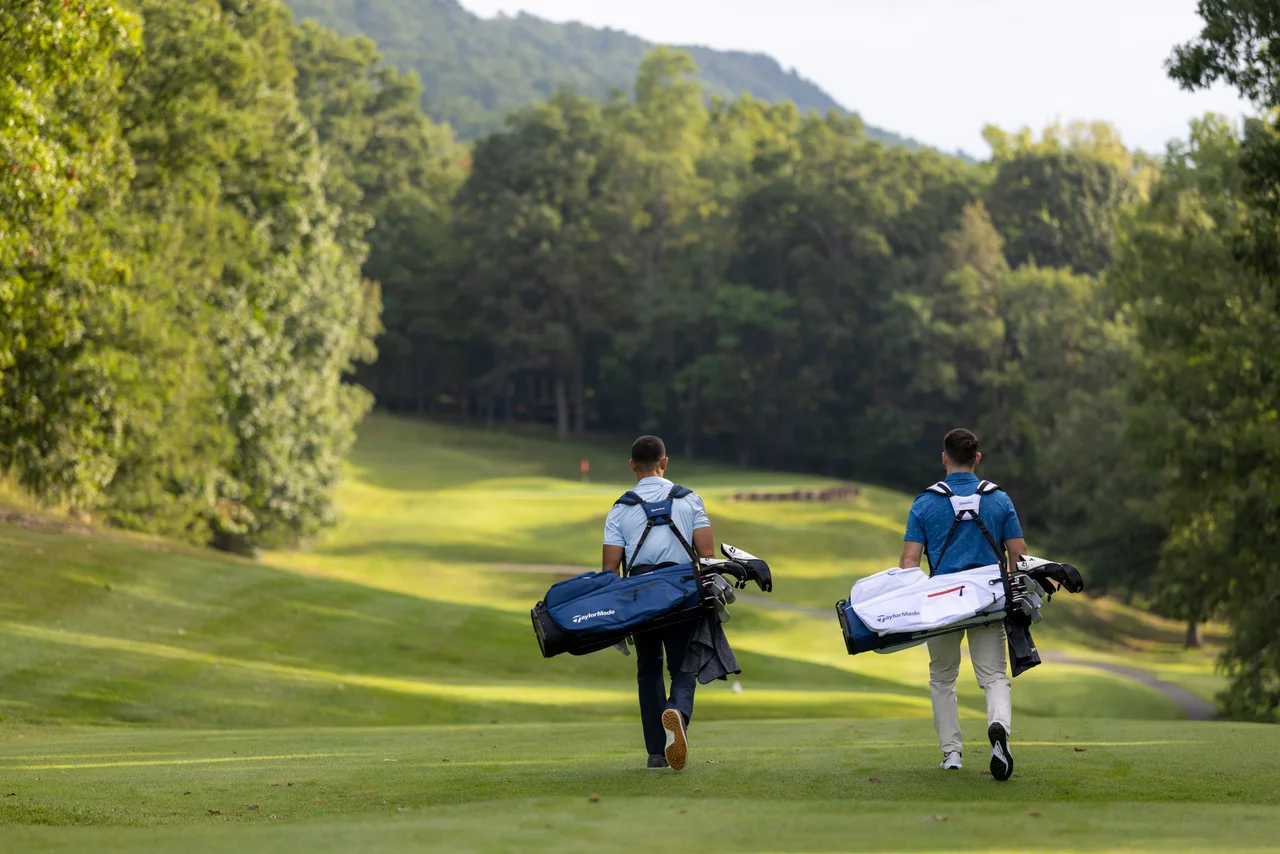Massanutten mountain greens two golfers walking wooded fairway wide