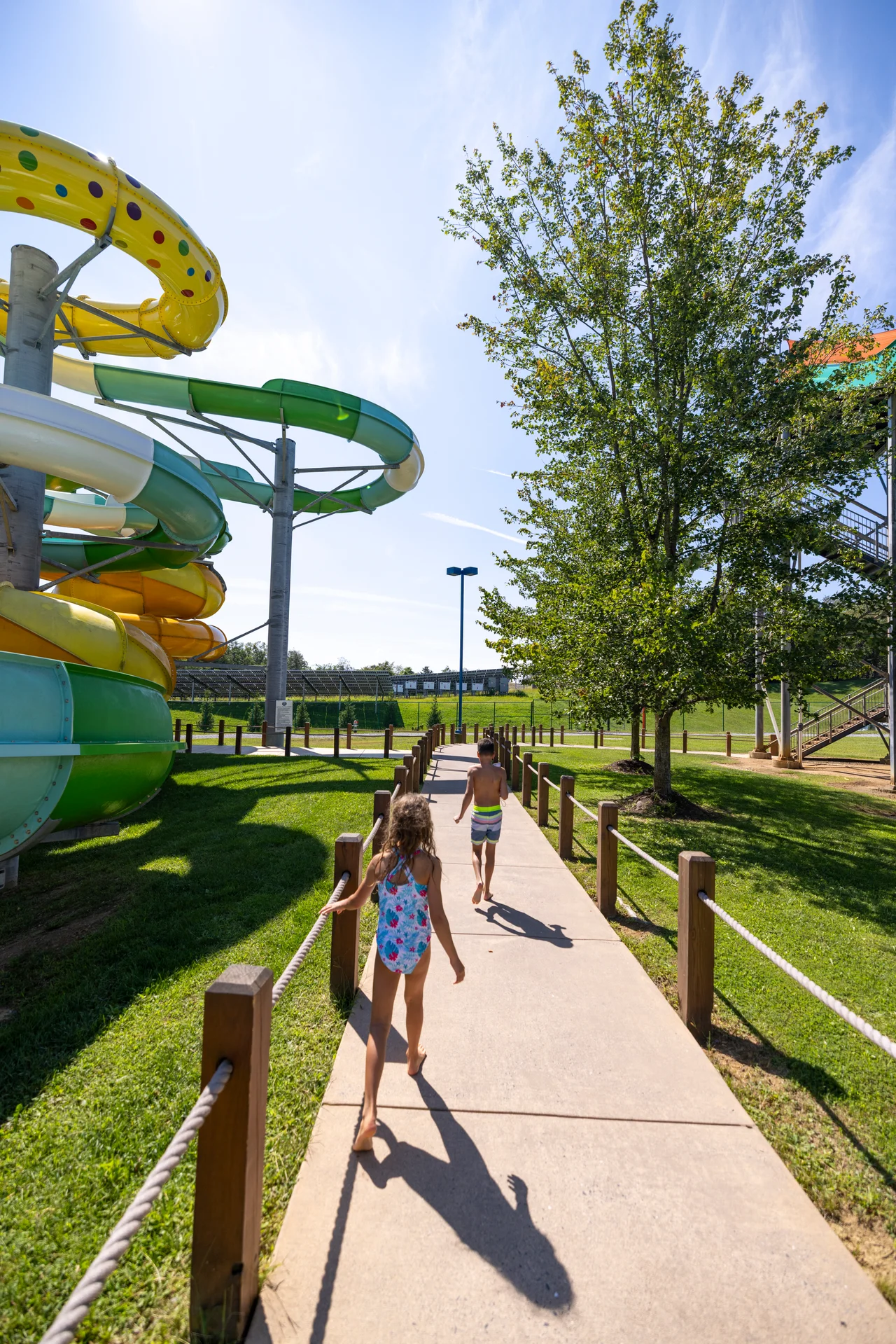 Massanutten outdoor waterpark family walking beside water slides