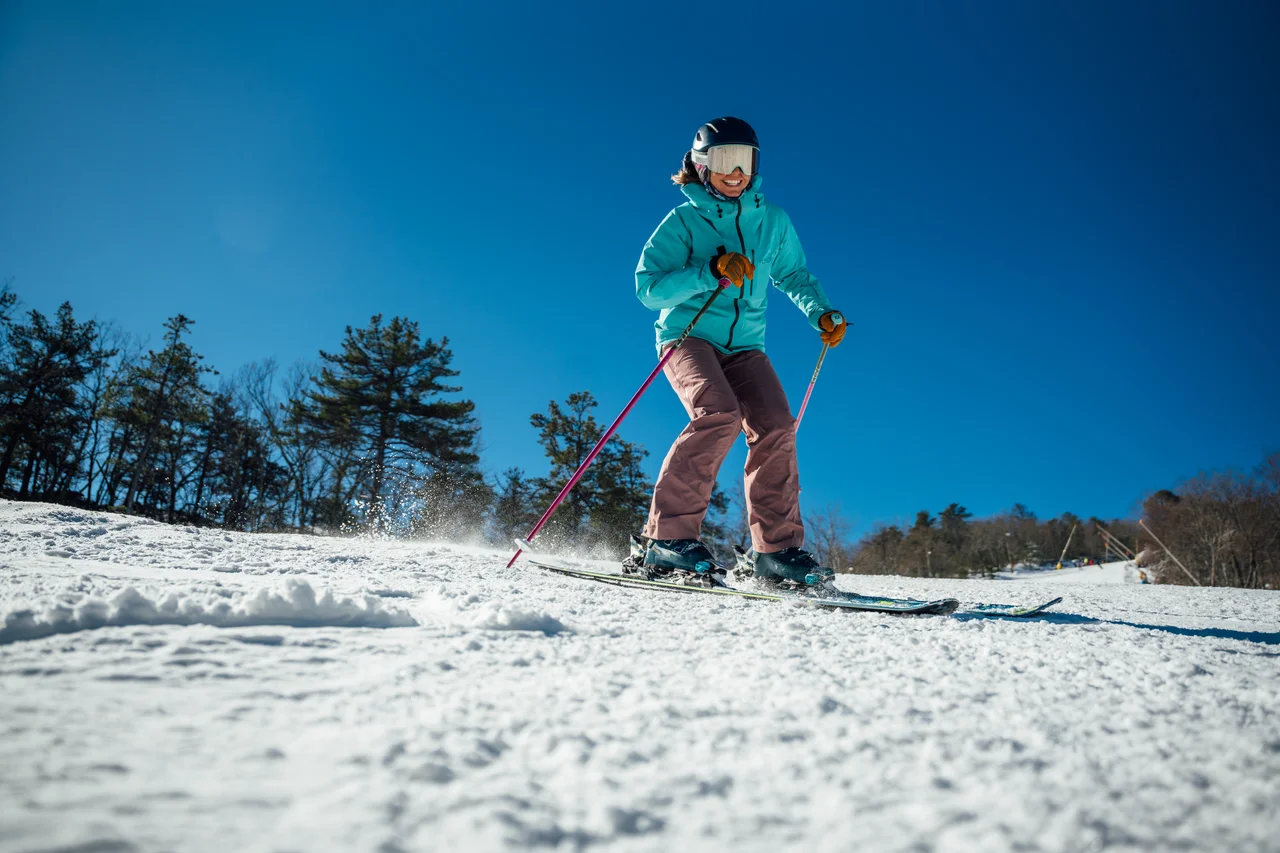Massanutten ski area general skier in green and pink on snow 13