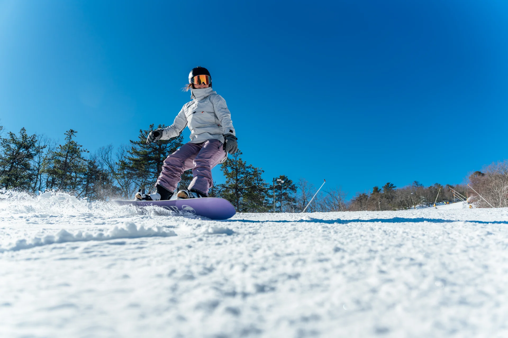 Massanutten ski area general snowboarder on sunny ski slope 12