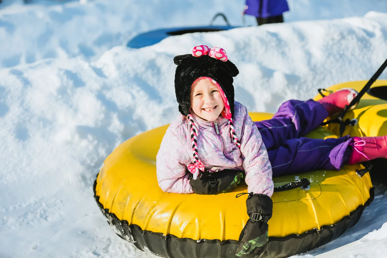 Massanutten snow tubing day smiling child on tube