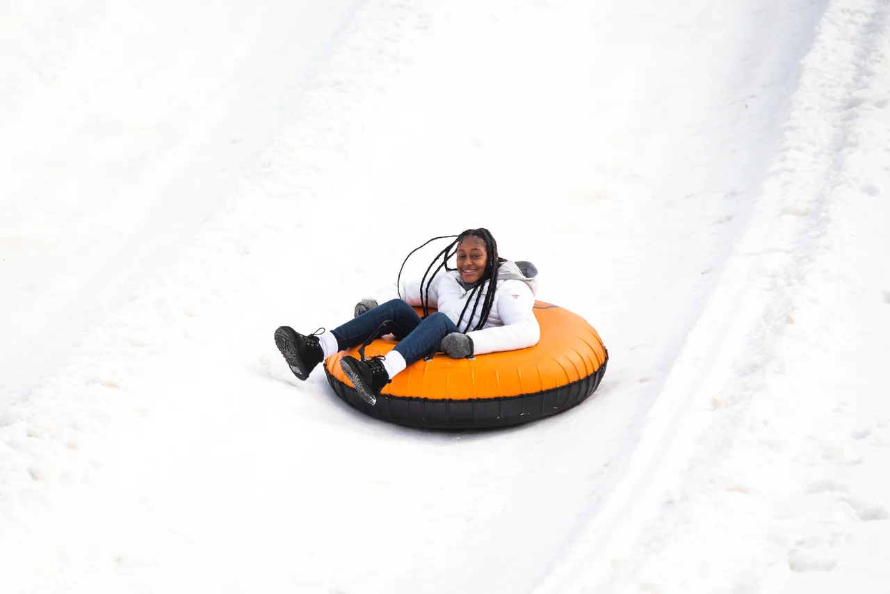 Massanutten snow tubing day woman on orange tube