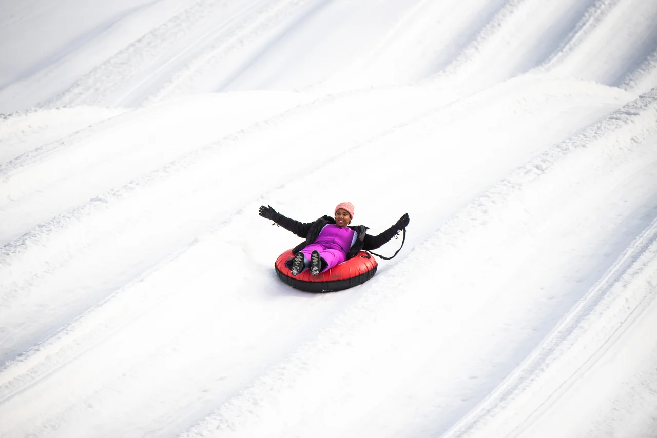 Massanutten snow tubing day woman on red tube