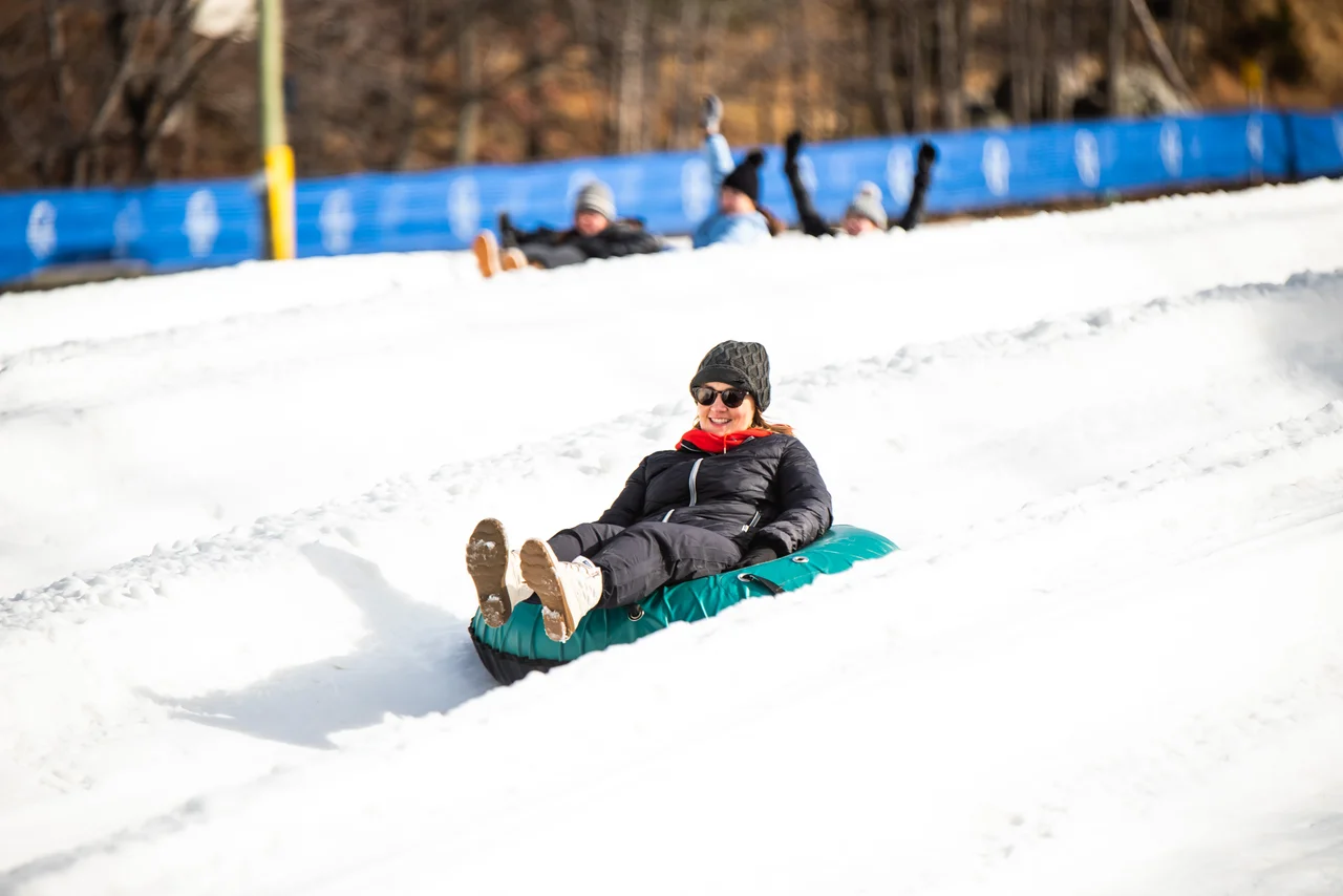 Massanutten snow tubing day woman riding green tube