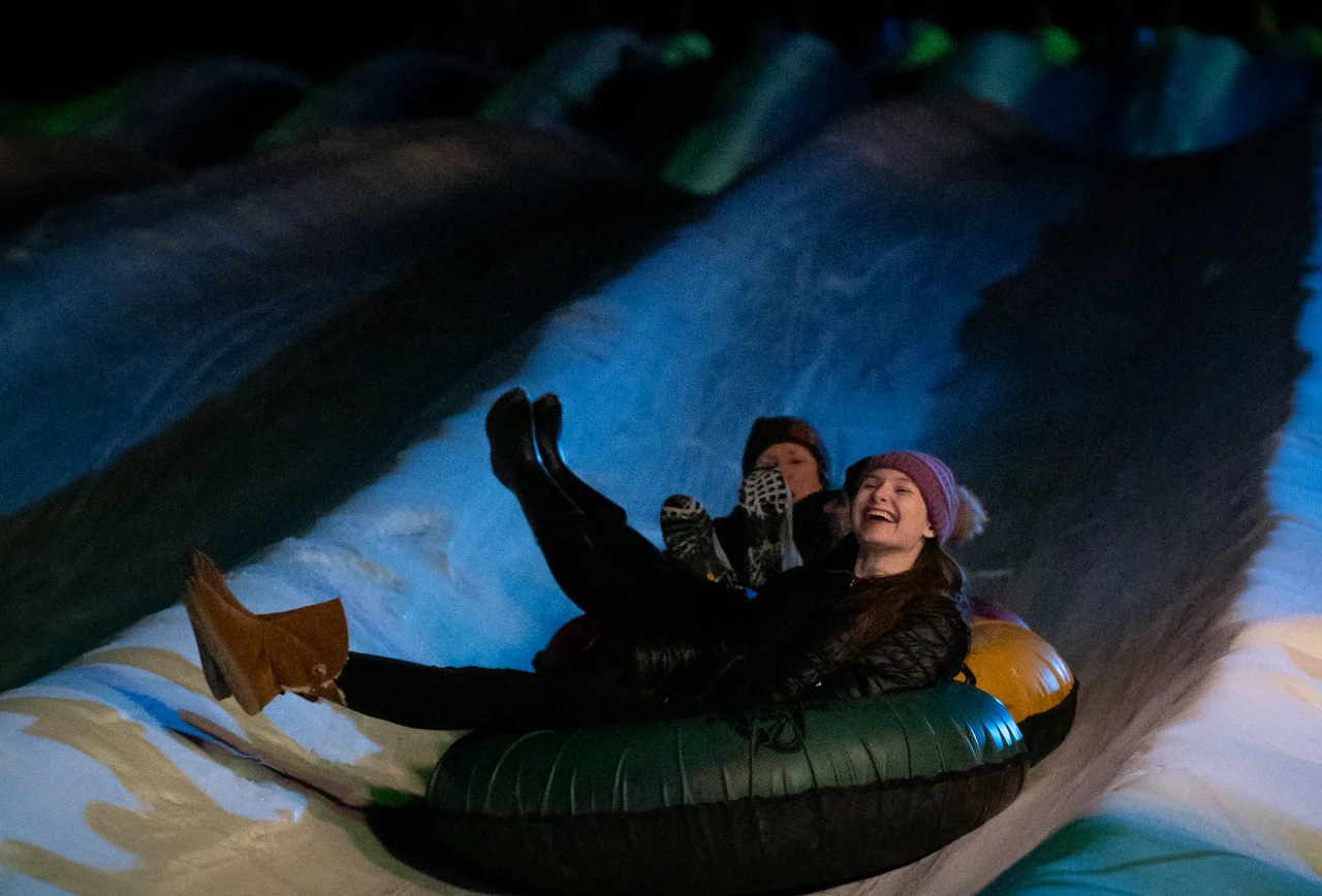 Massanutten snow tubing night women riding tube