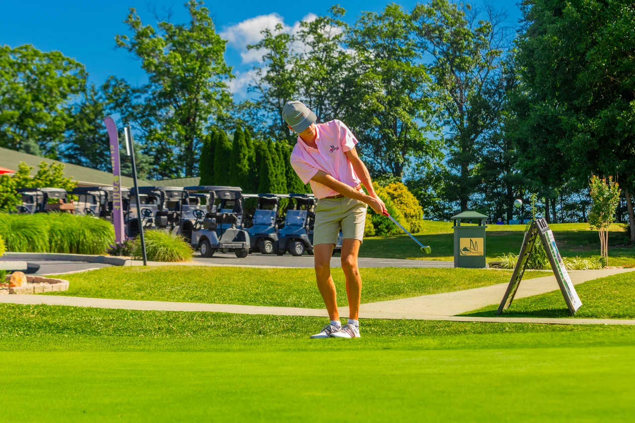 Massanutten woodstone golfer putting near golf carts